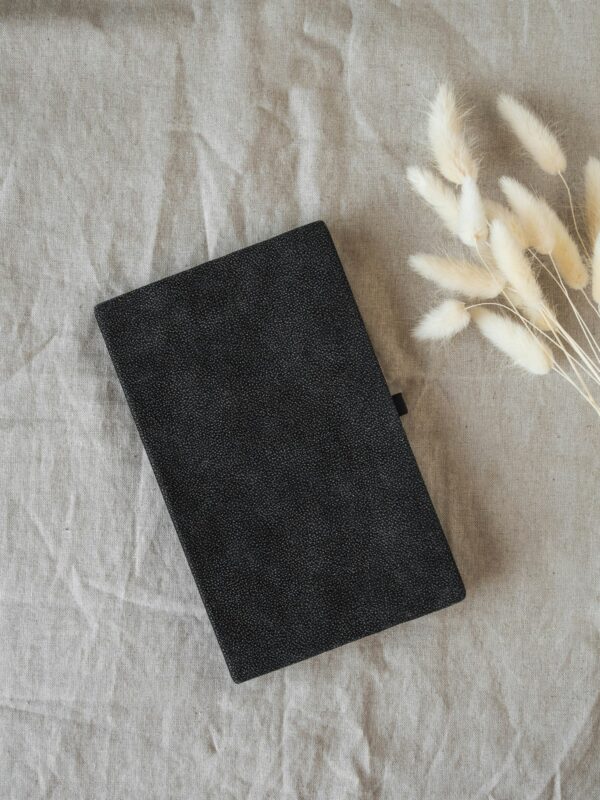 Black pocket journal and dry flowers